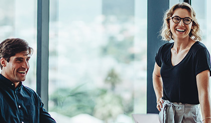 Woman and man smiling in a meeting