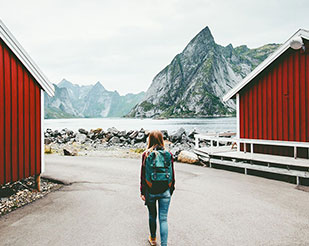 Woman walking by a fjord in Northern Norway