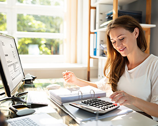 Woman sitting in front of computer at home office