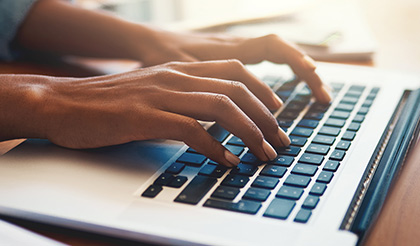 Person typing on a keyboard