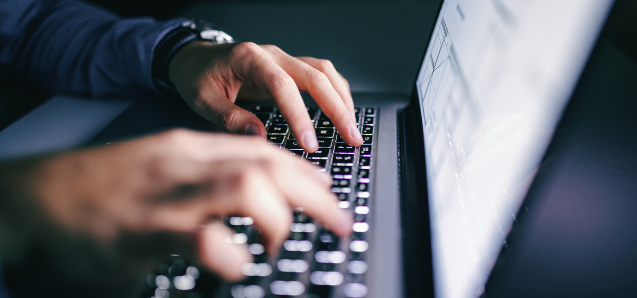 Person typing on a laptop keyboard