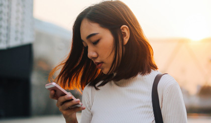 Asian woman looking at her phone