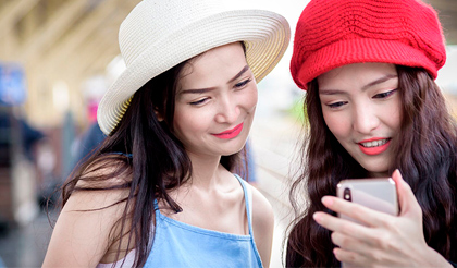Two asian women looking at a phone