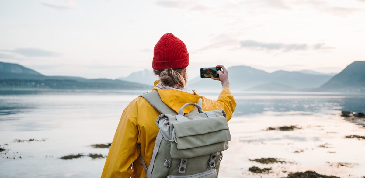Woman taking a photo of nature in Norway