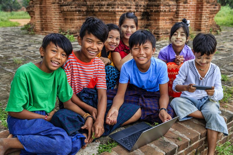 Group of children in Asia in front of a computer