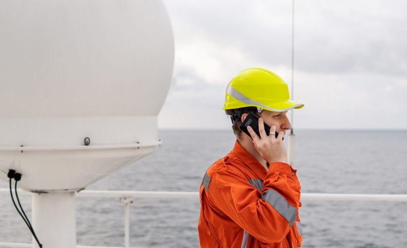 Marine Deck Officer on a ship speaking on the mobile phone.