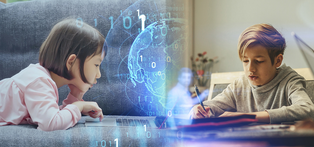 Children looking at computer and writing