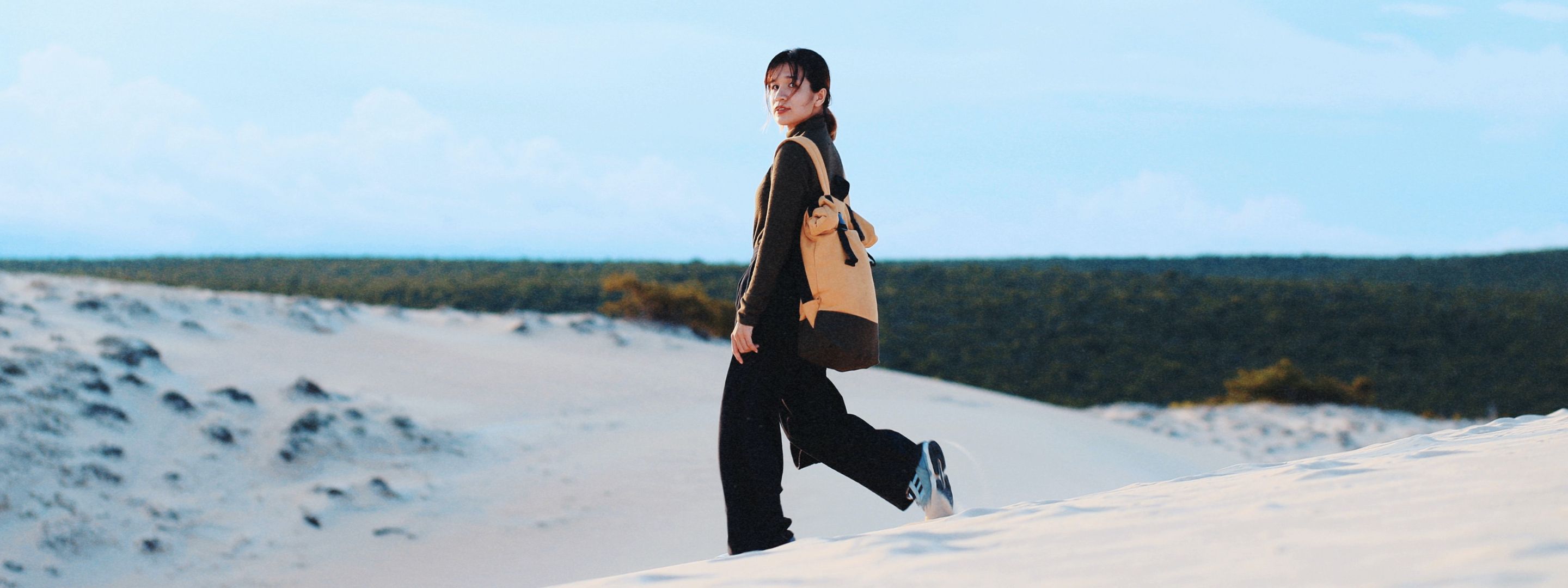 Girl walking in desert.