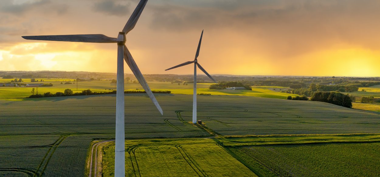 Wind turbines producing electricity on a field in Denmark.