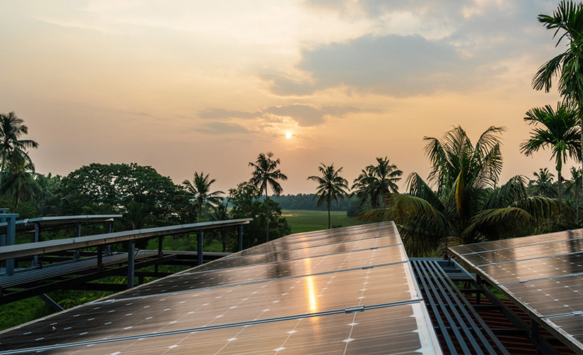 Solar panel with a sunset in the background