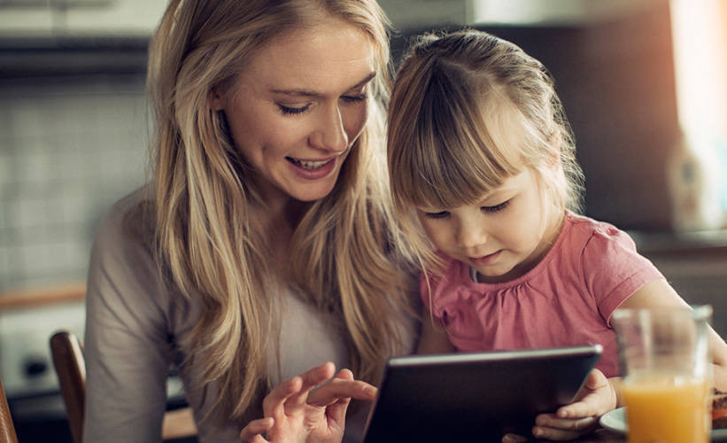Mother and child looking at a tablet together