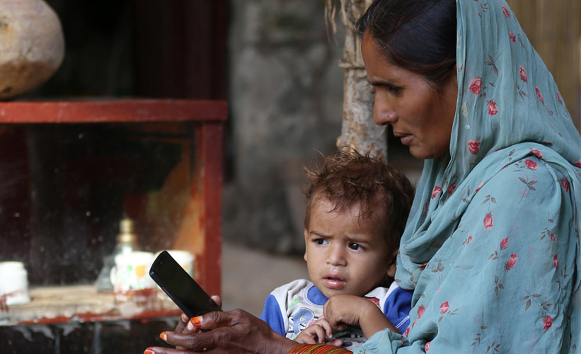 Woman and her son looking at a mobile phone
