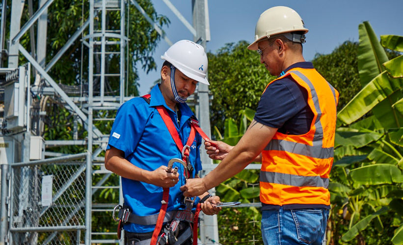 Two workers at a base station in Thailand