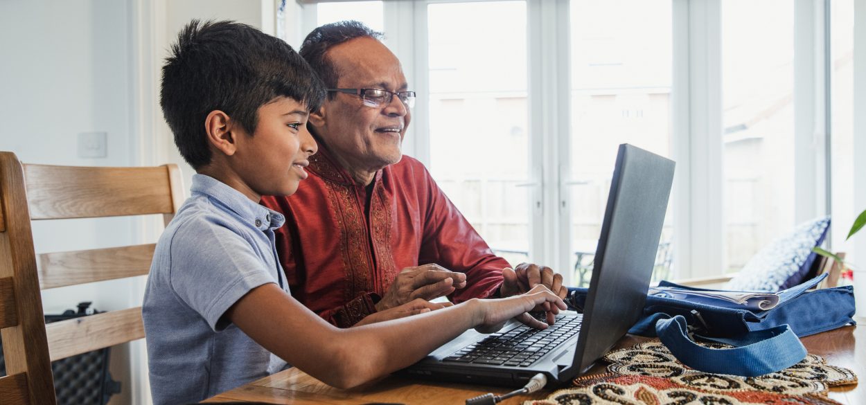 Father and son working on the computer together