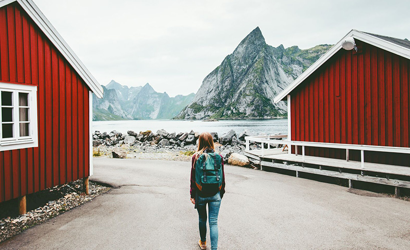 Woman walking by a fjord in Northern Norway