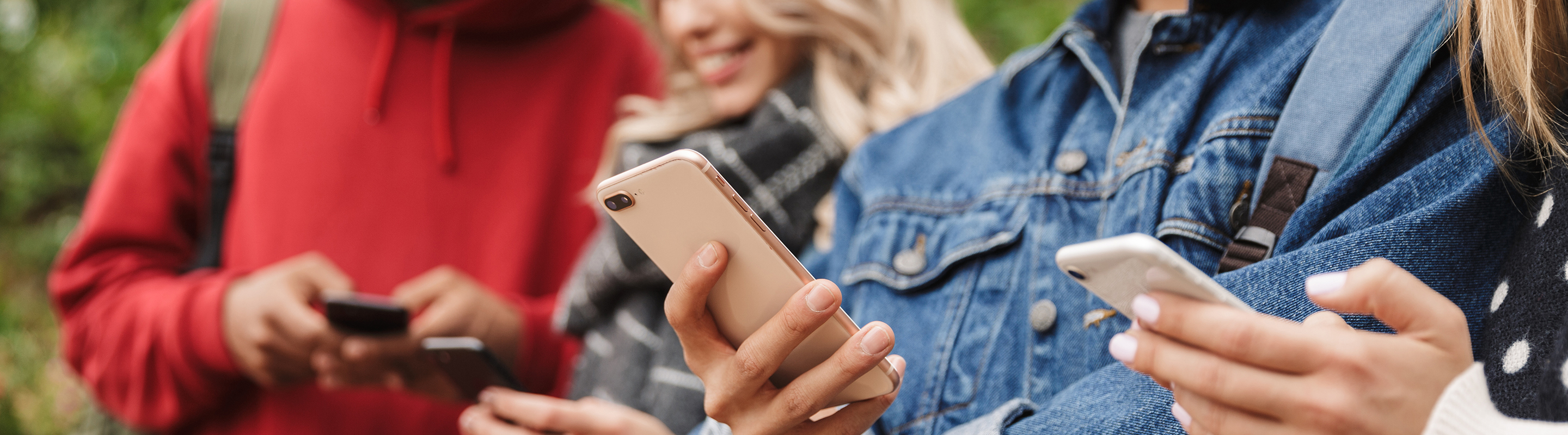 Close-up of a group of people browsing on their phone